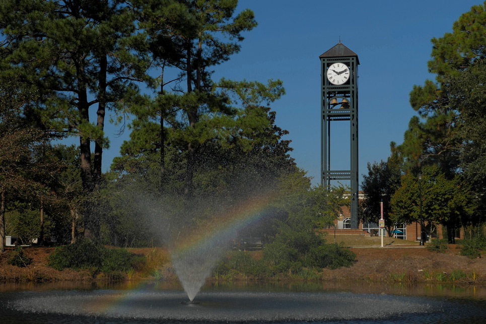 UNCW Clocktower with a rainbow in the fountain’s mist