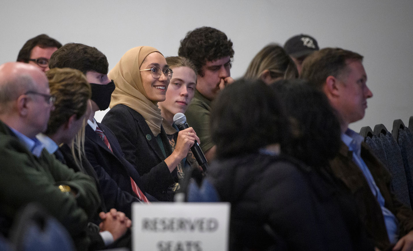 Lecture attendee holding microphone in the audience