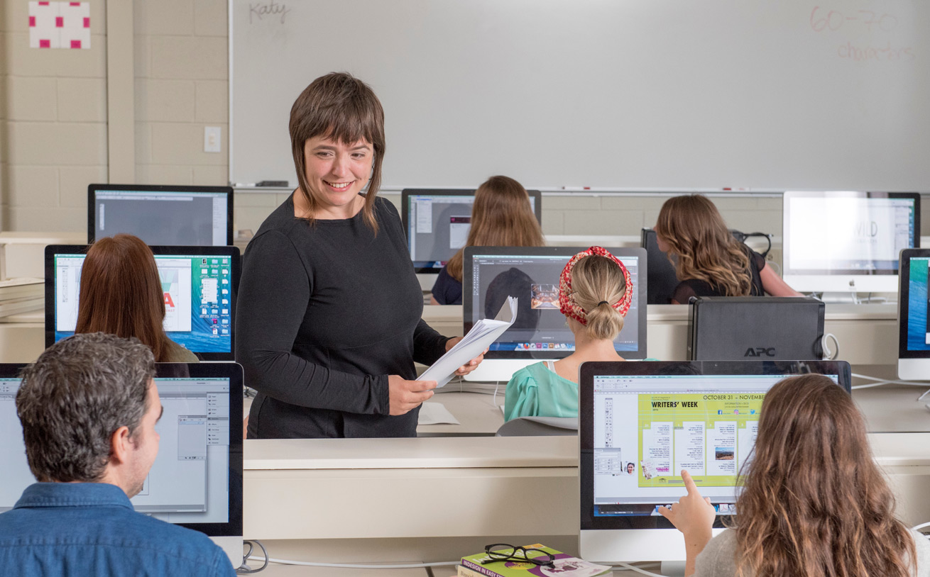 students learning in a classroom with computers.