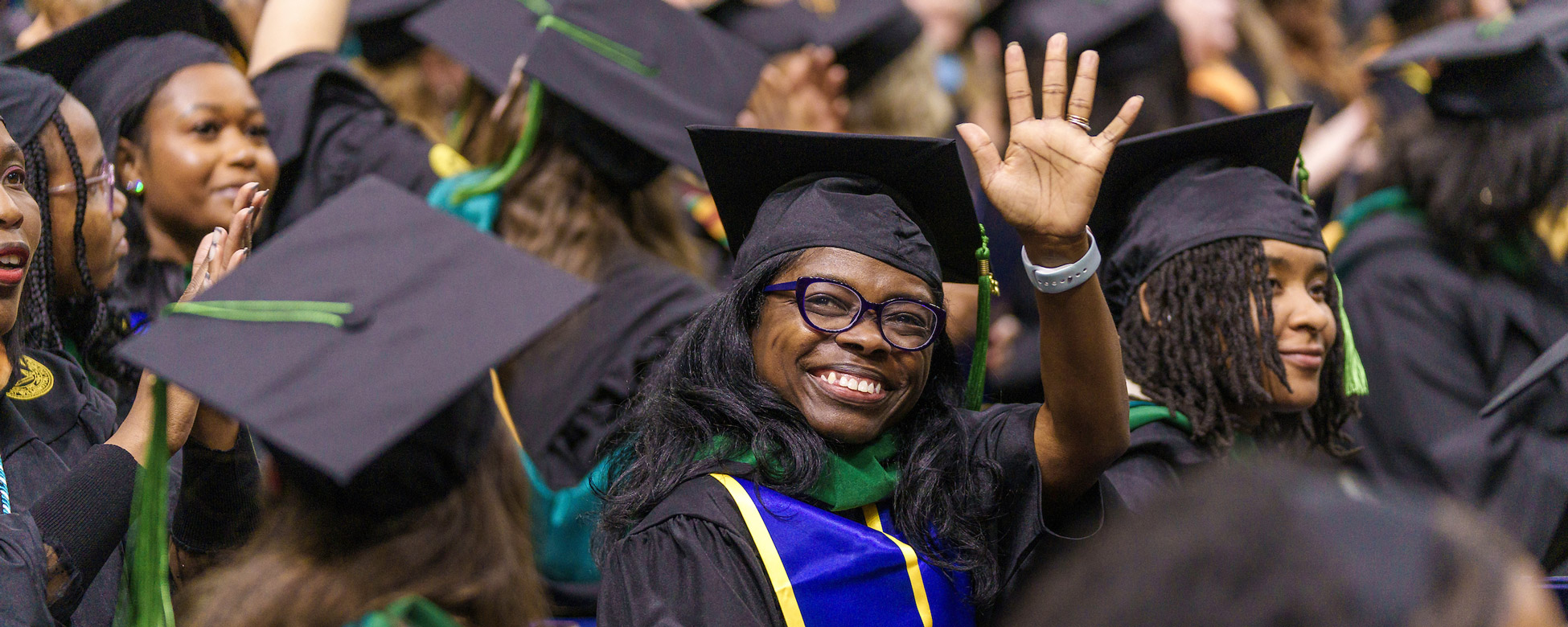 Student waves during the commencement ceremony