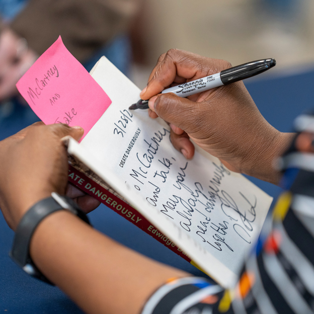 Writing on book at event