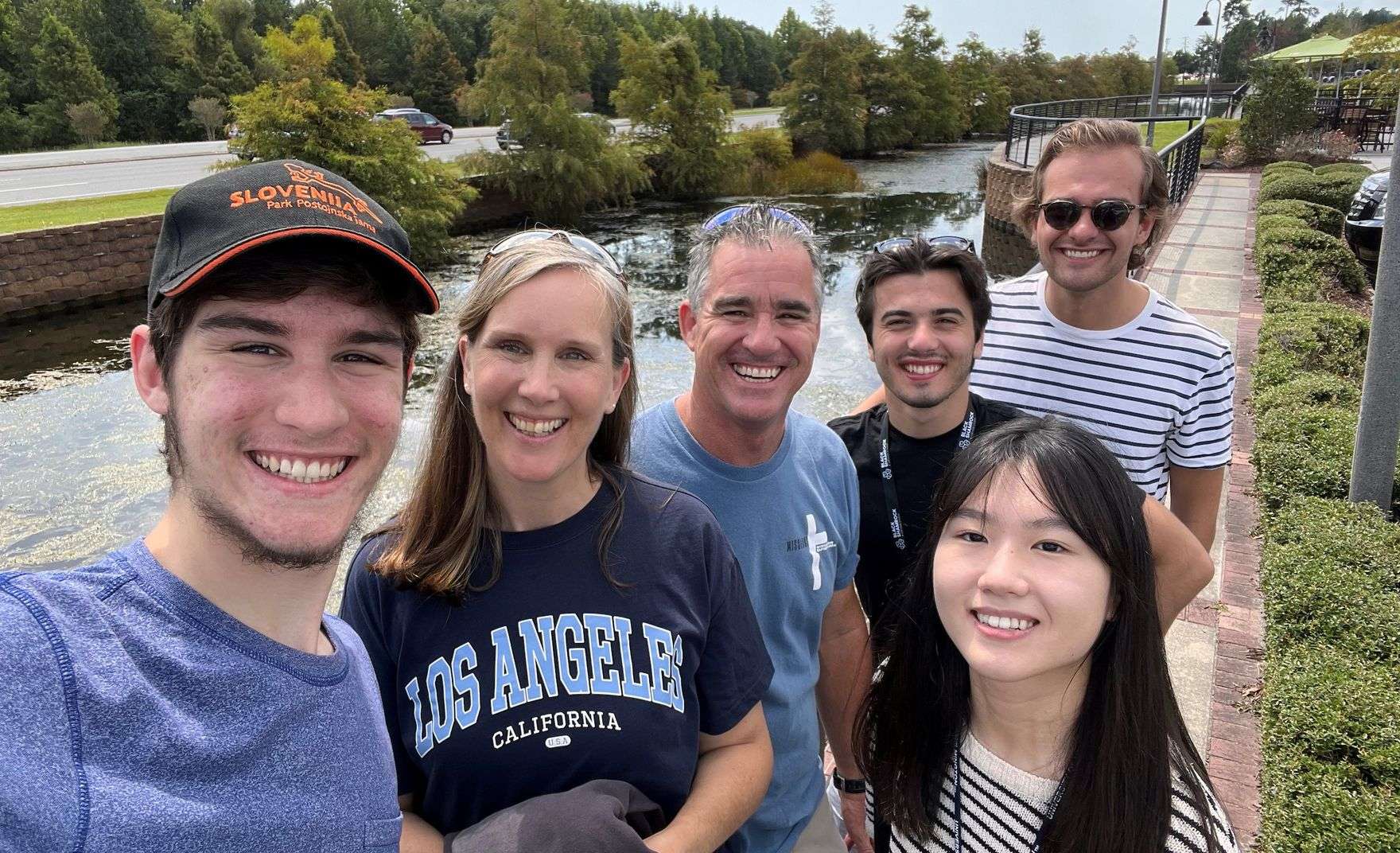 6 students standing in front of a water way