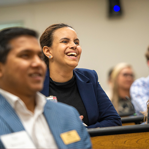 students laugh while seated in class