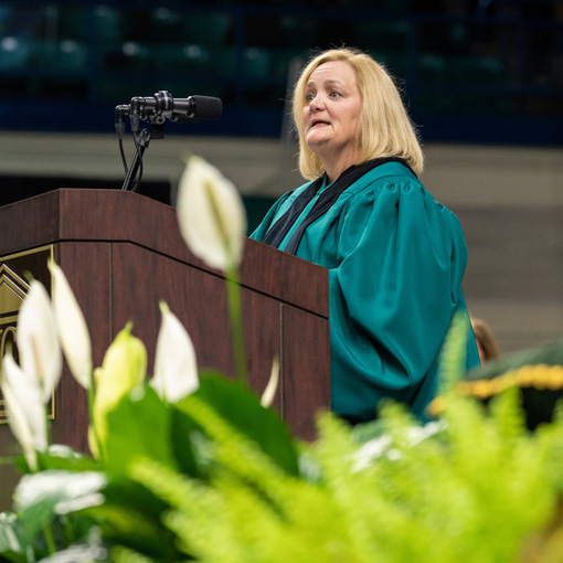 Staff Senate Chair speaking at Commencement