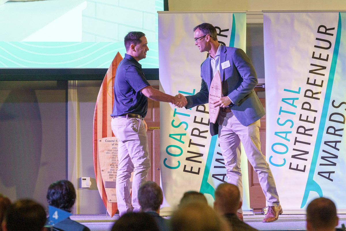 man accepting award on stage