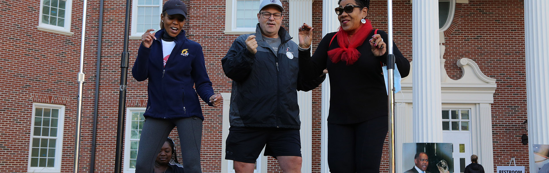 3 people dancing on UNCW campus