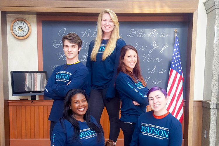 Five Watson students pose in classroom