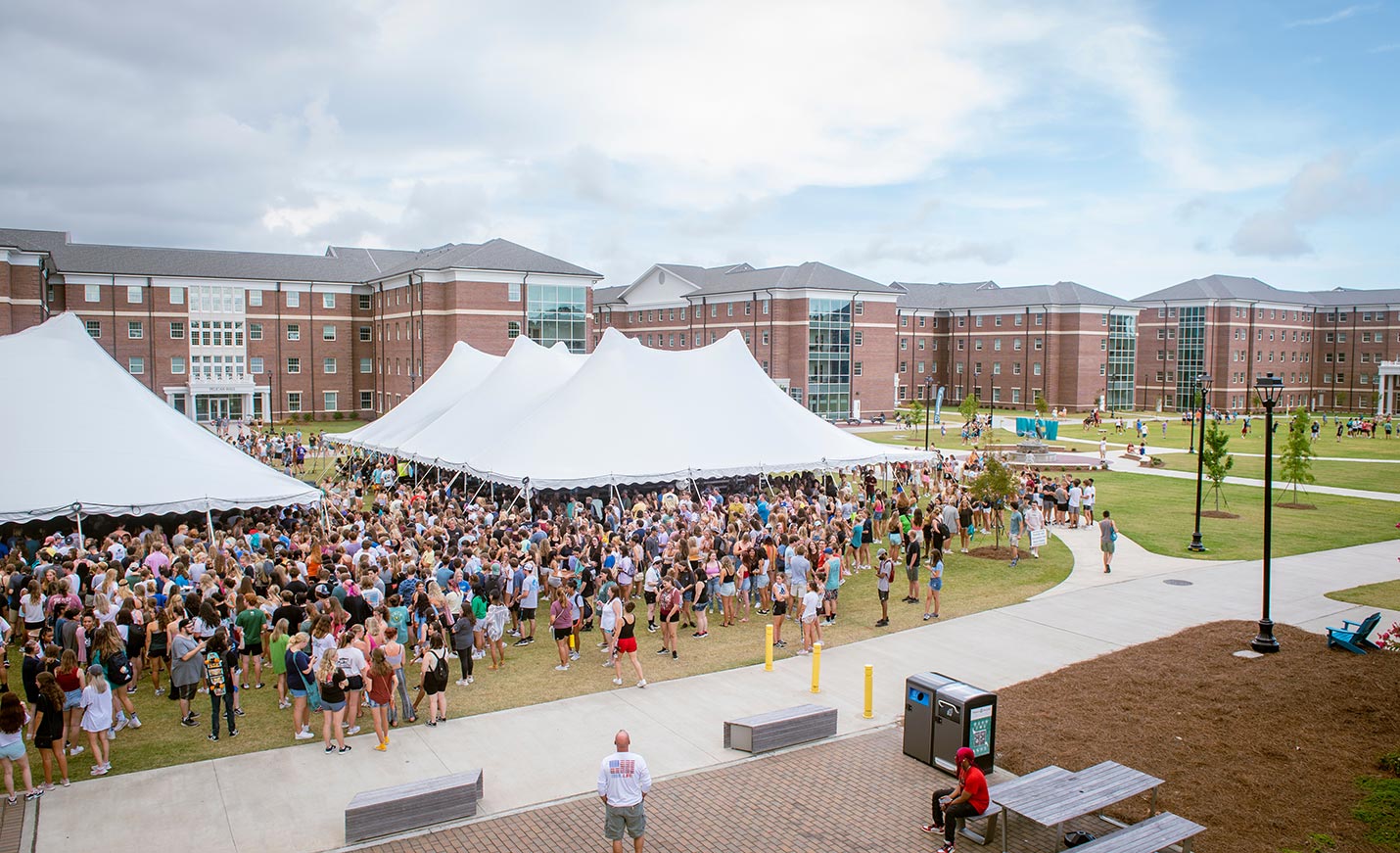 Following convocation, incoming students, faculty, staff and administrators gather for lunch under the tents on Hoggard Lawn