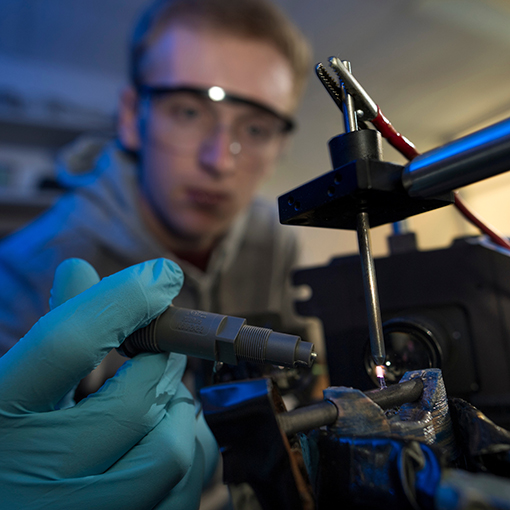 A student using a machine in a Chemistry lab