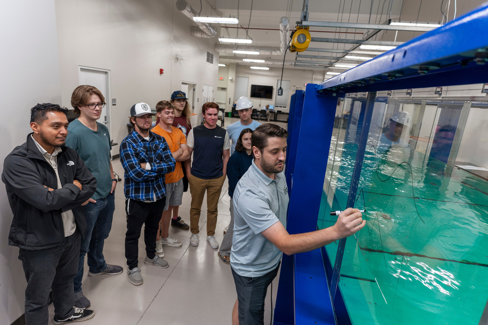 Dr. Ryan Mieras and his students use the UNCW Coastal Engineering Wave Flume, recently commissioned in 2023, to run controlled experiments.