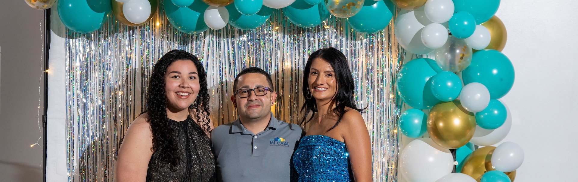 3 people pose for camera at Homecoming Formal