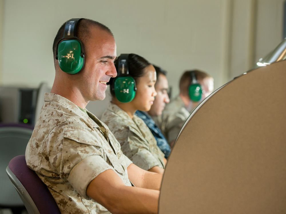 Military member wearing headphones