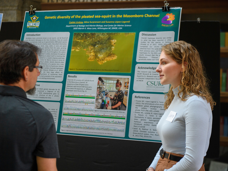 Student presenting research poster