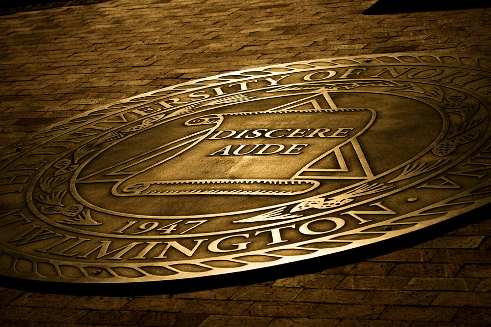 Bronze colored UNCW University seal