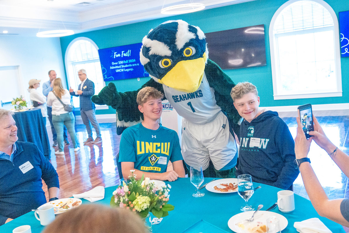 Sammy C. Hawk poses with future students 