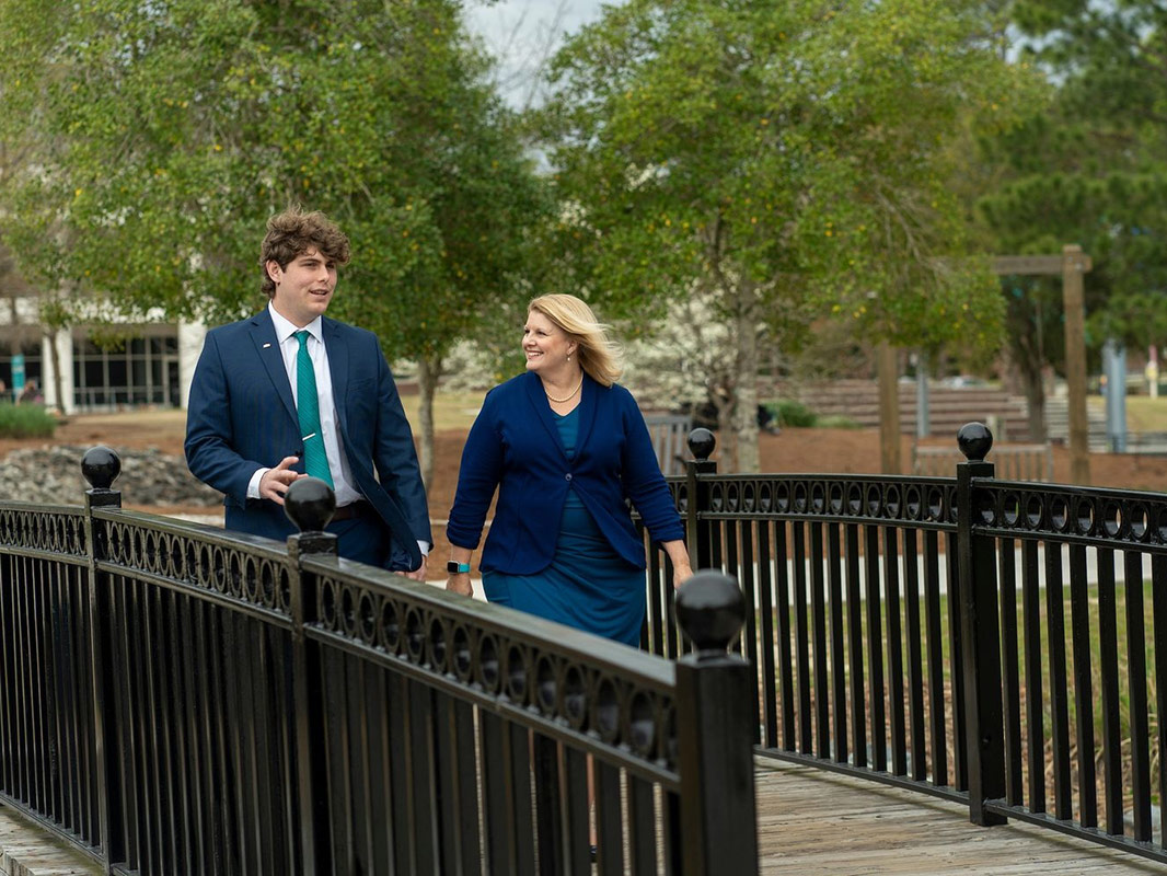 Skyler Stein and Christine Reed Davis walk together on campus