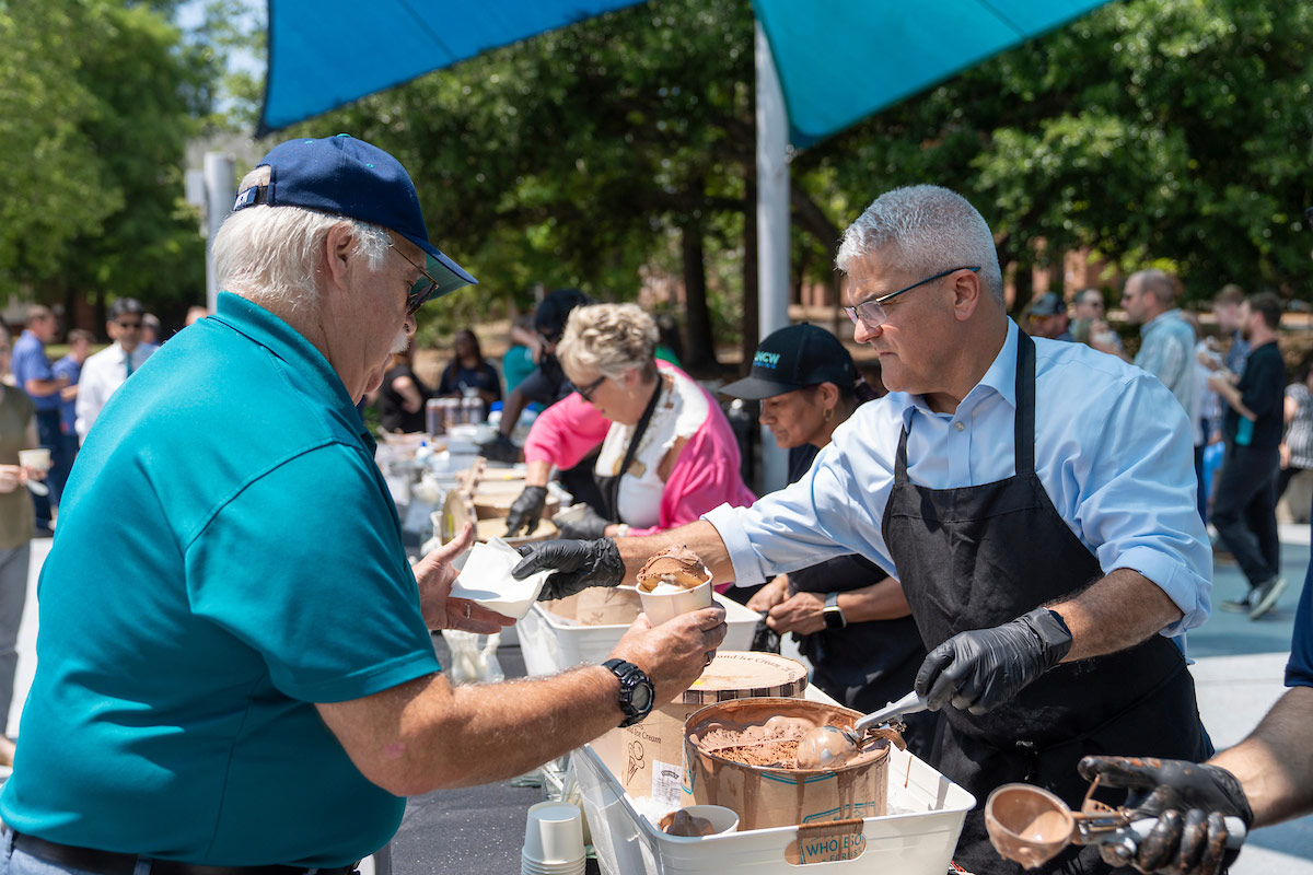 Provost Jamie Winebrake scoops ice cream in the UNCW Amphitheater