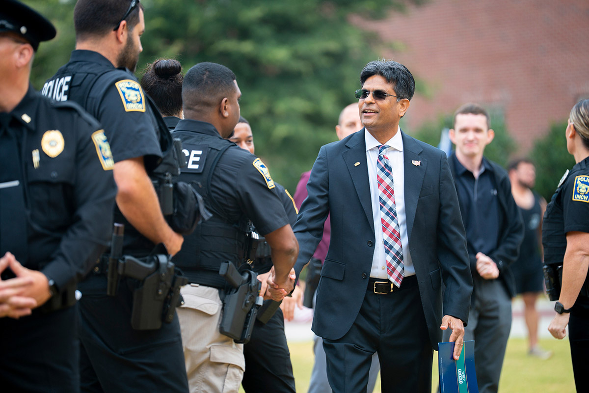 Chancellor Volety greets UNCW Police officers during a remembrance ceremony held by the Office of Military Affairs for the 24th anniversary of the Sept. 11, 2001, attacks. 
