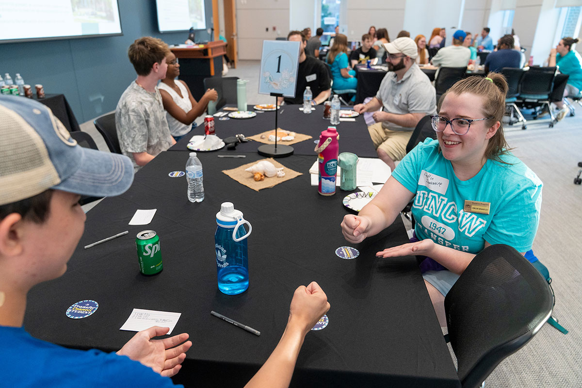 Mentors and new transfer students engage at a table during the Transfer Connect Mentor Kickoff