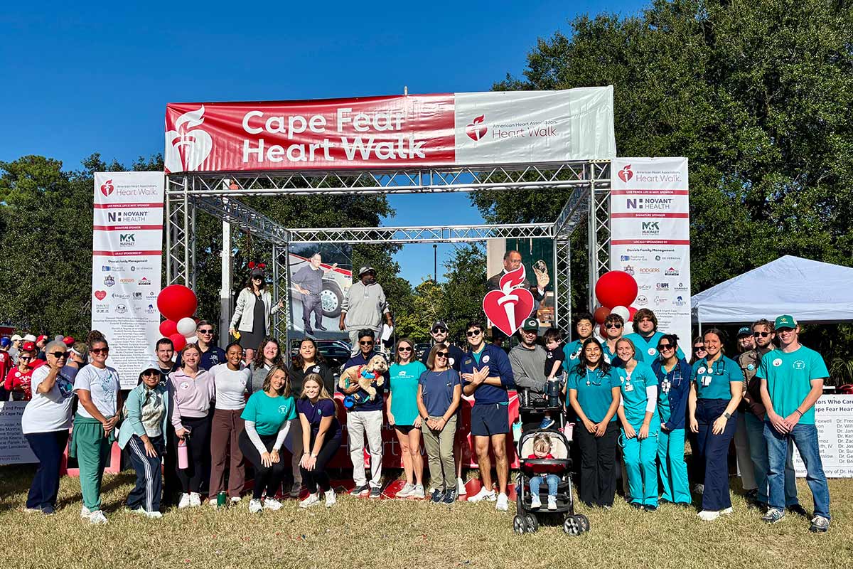 Members of Team UNCW in front of the Cape Fear Heart Walk stage on campus