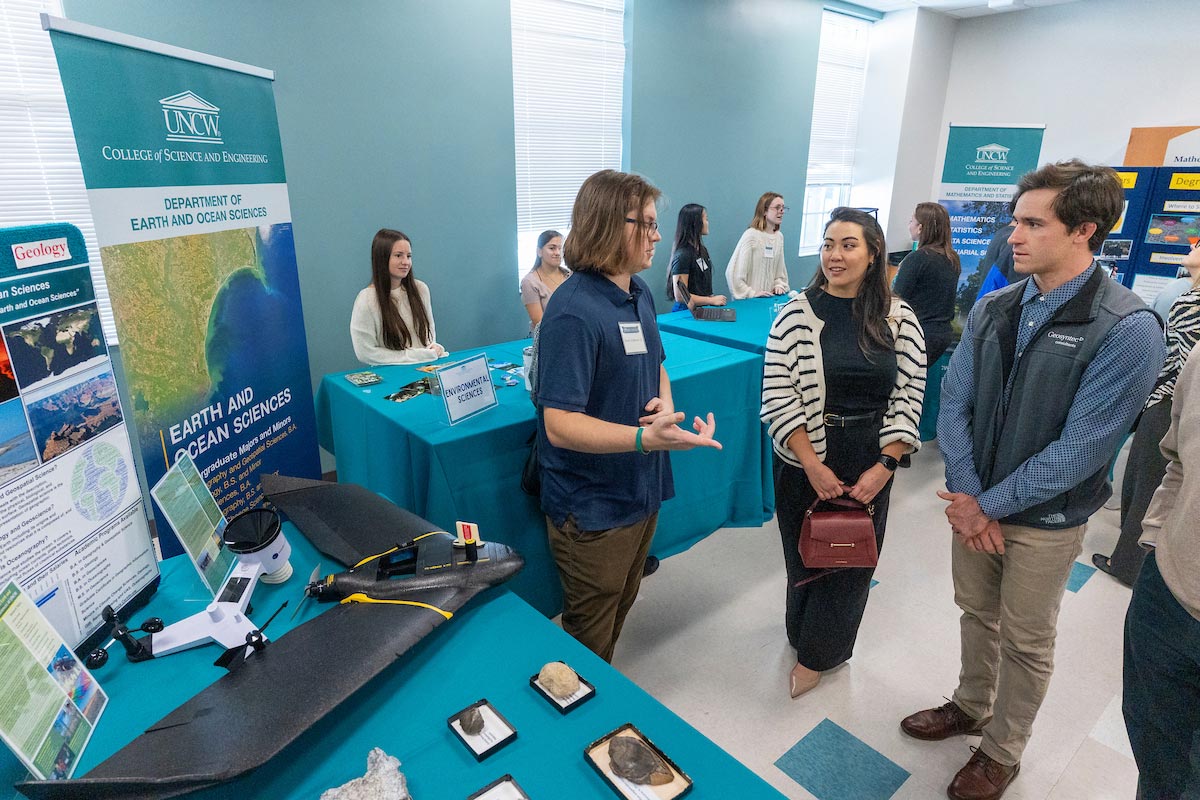 Students present their work at tables to 