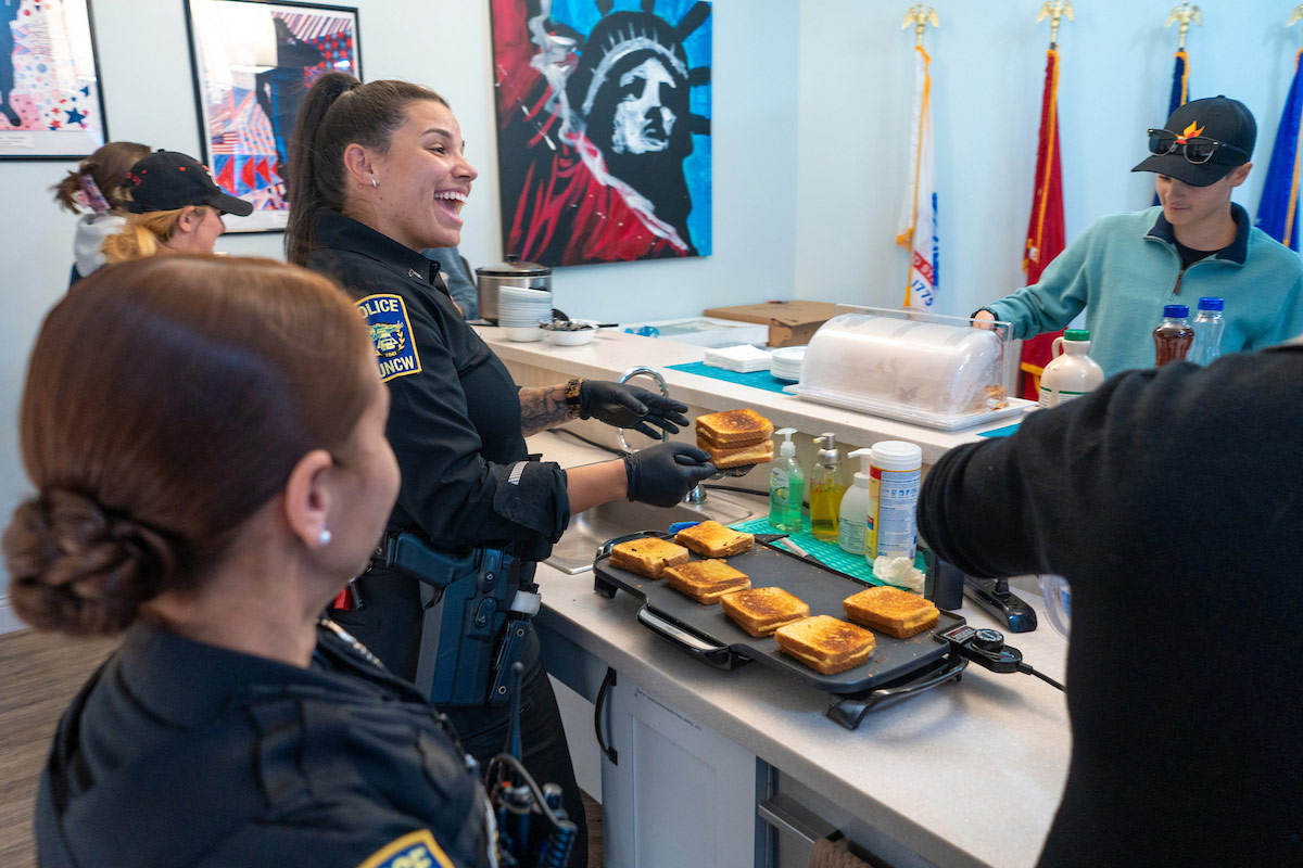 University Police officers make grilled cheese sandwiches 