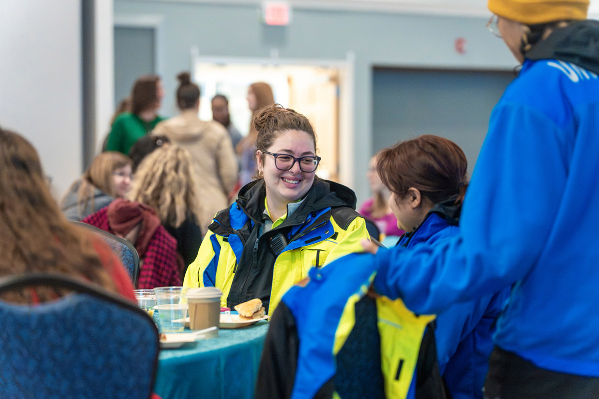 Staff members around a table enjoying breakfast