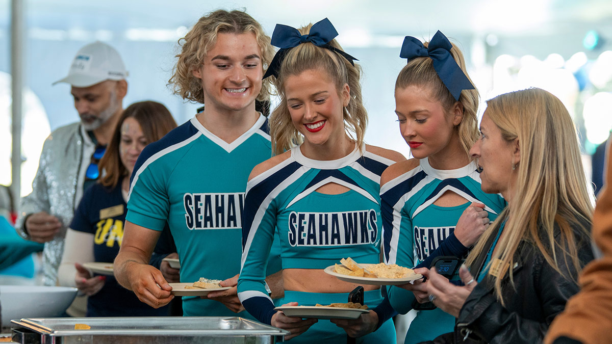 UNCW cheerleaders help themselves from the buffet at the TEALgate celebration