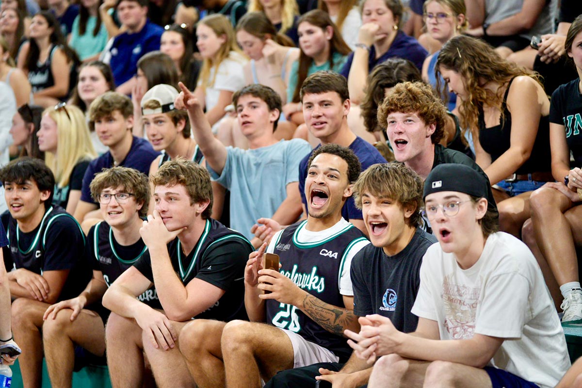 Students cheer in the stands of Trask Coliseum