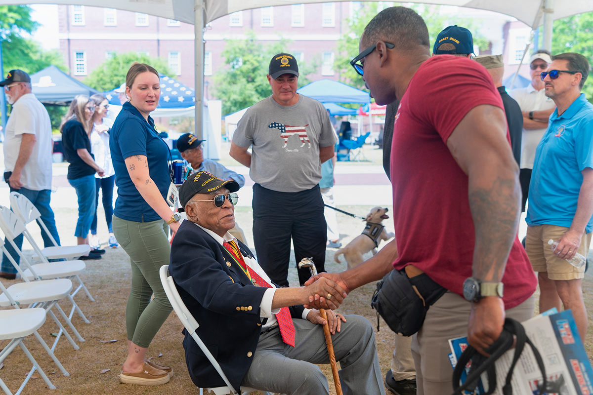 A man shakes hands with Major James Capers