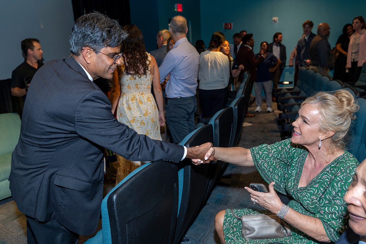 Chancellor Volety shakes hands with a women at the New Hanover Healthcare Career Partnership forum 