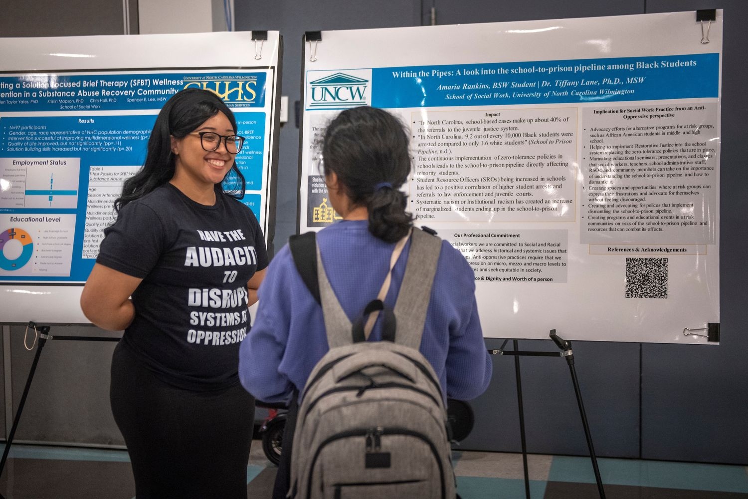 Amaria Rankins (left) a Bachelor of Social Work student presents her research project during an interactive poster session. 