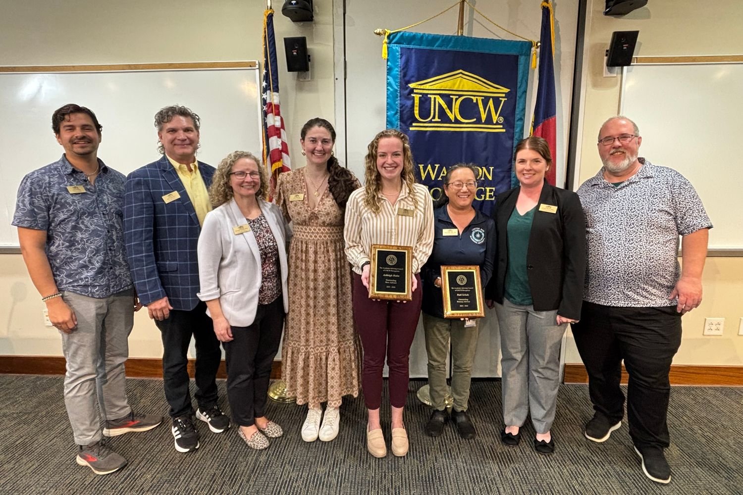 Awards ceremony nominees posing together. 
