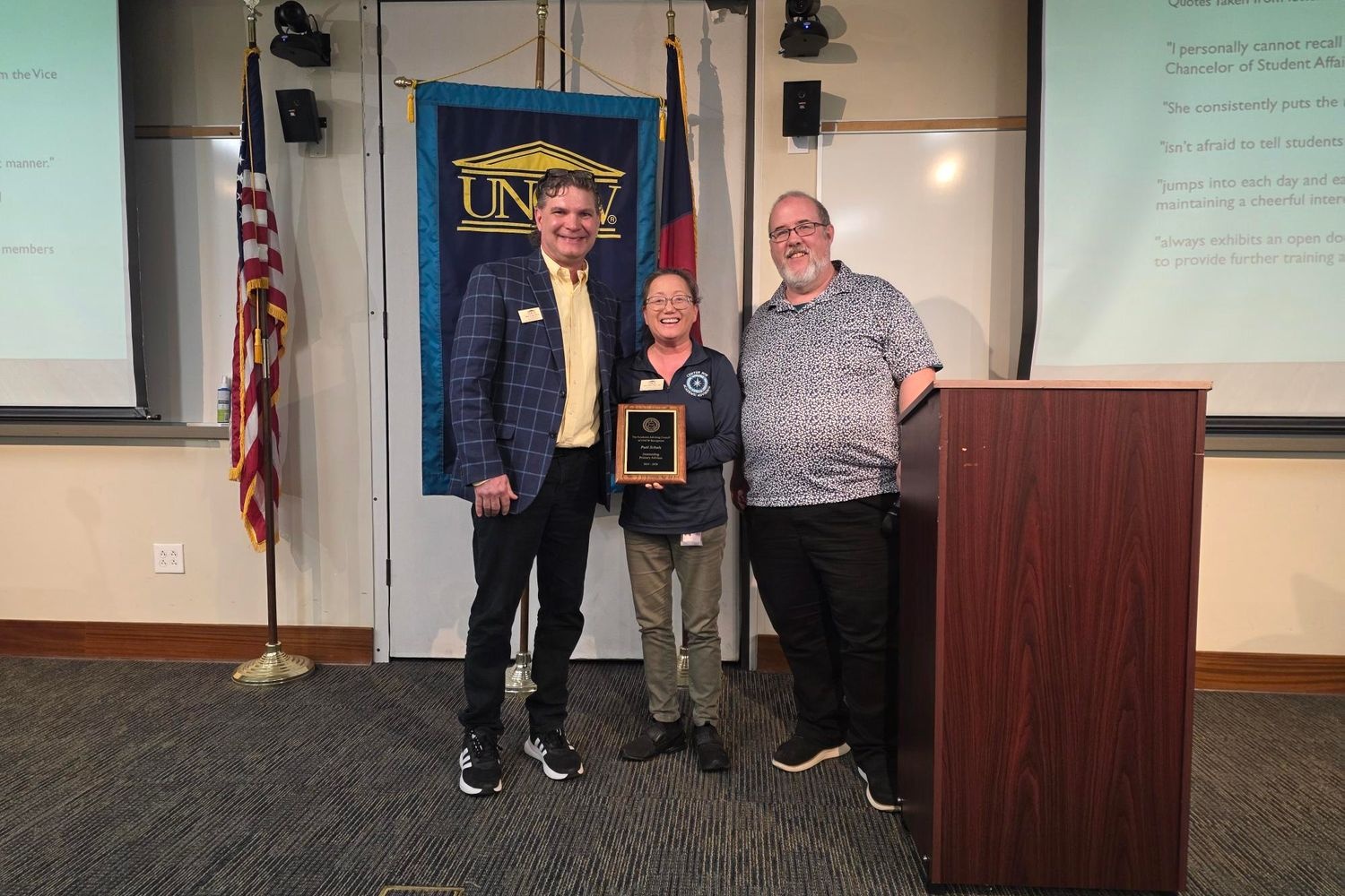 People posing for awards ceremony. 