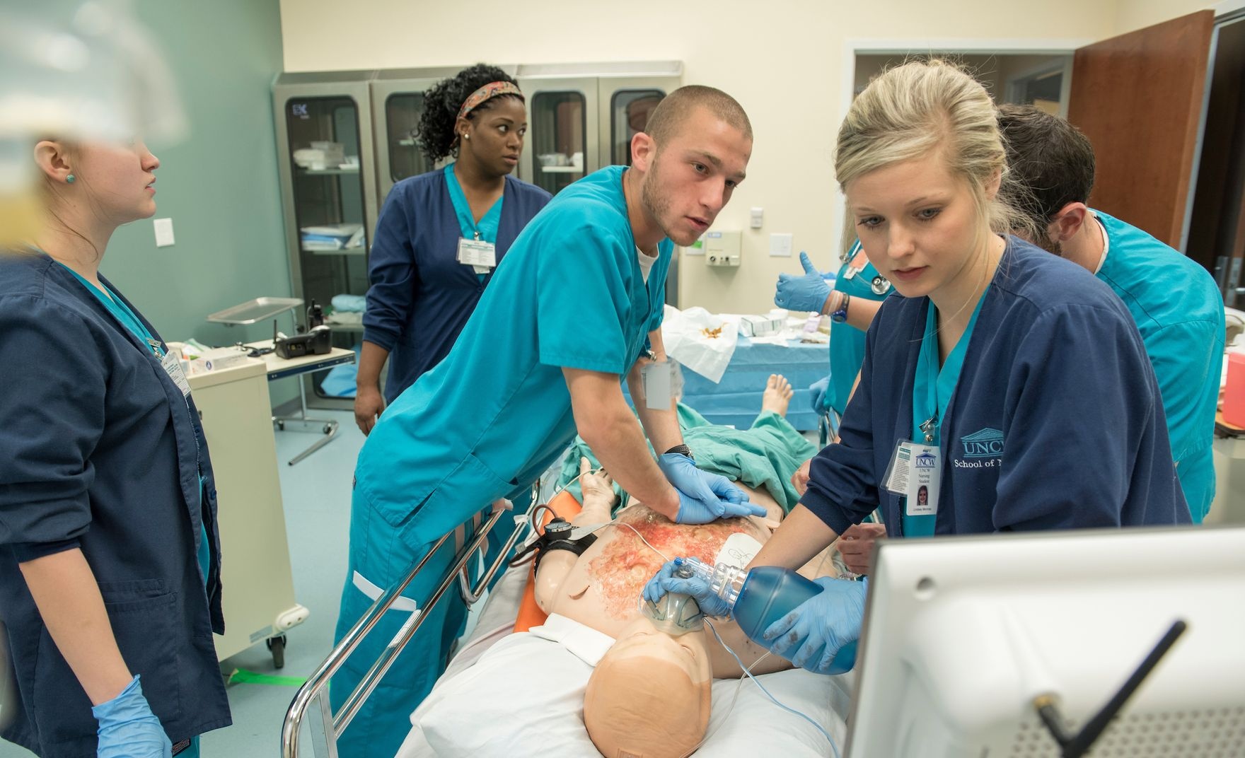 Student giving CPR in nursing simulation