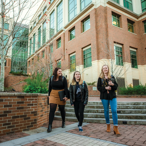 Three students walking on a community college's campus