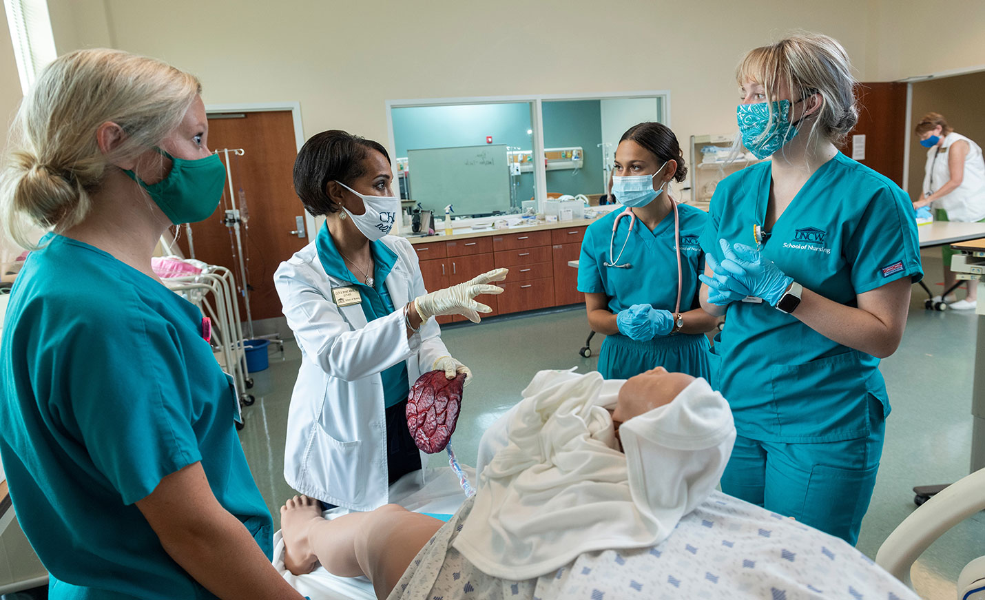 Nursing students practice with a labor and deliver dummy