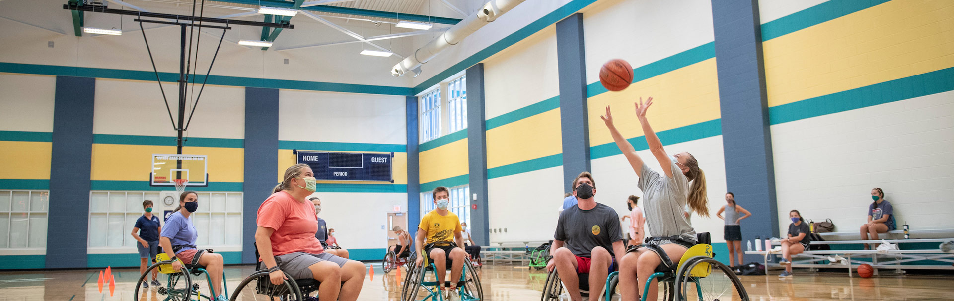 Students in wheelchairs playing basketball