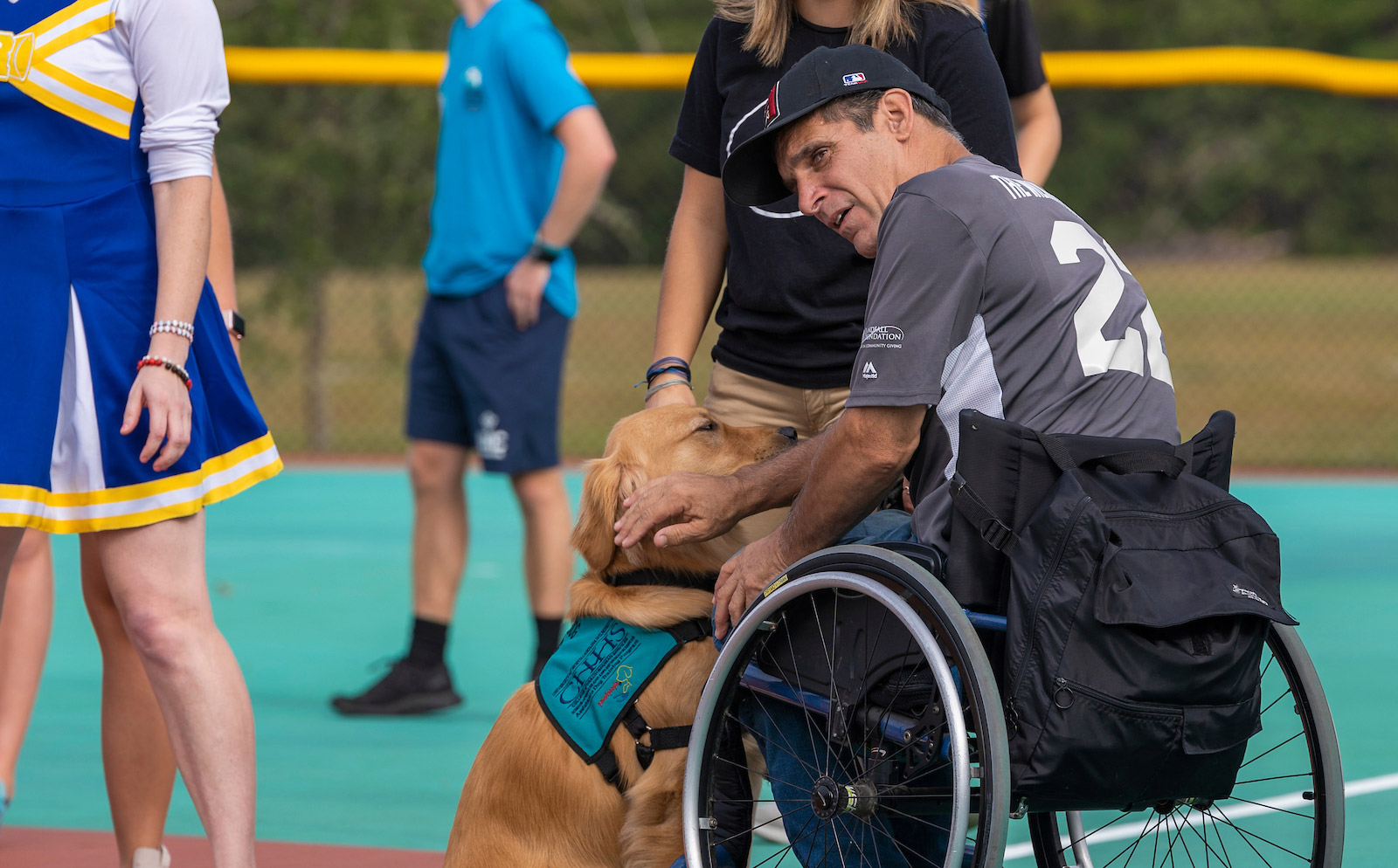 Service dog assists athlete in wheelchair