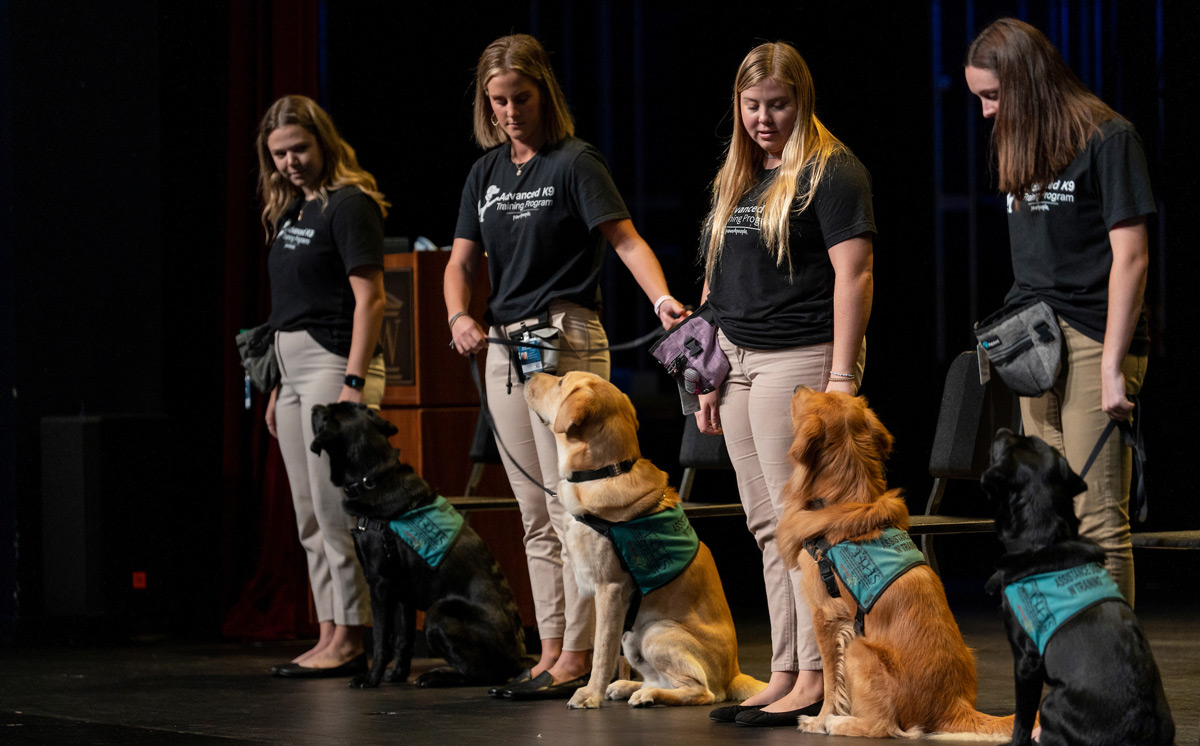 Service dogs graduate from training with the their student trainers by their side. 