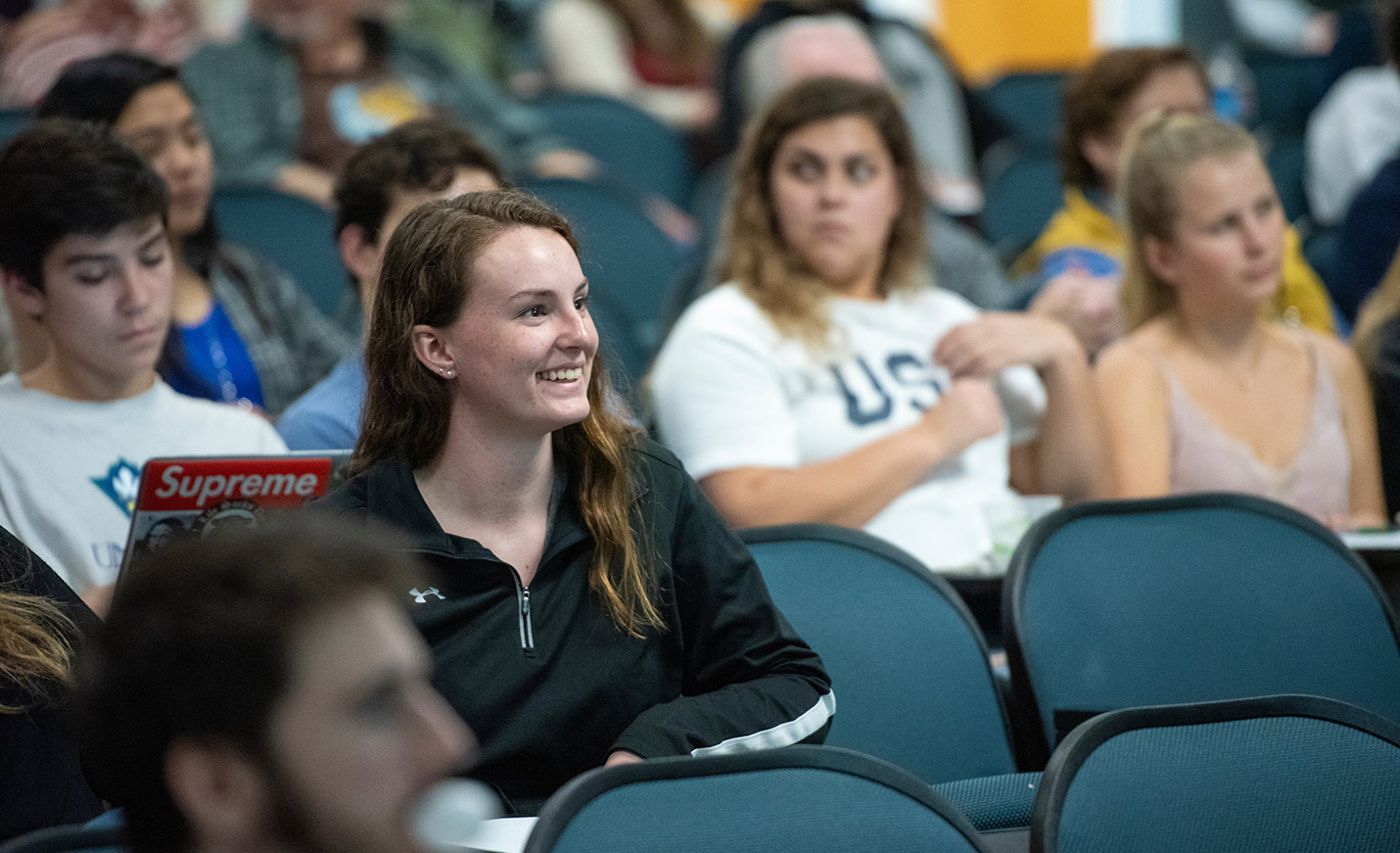 Smiling students sitting in lecture hall