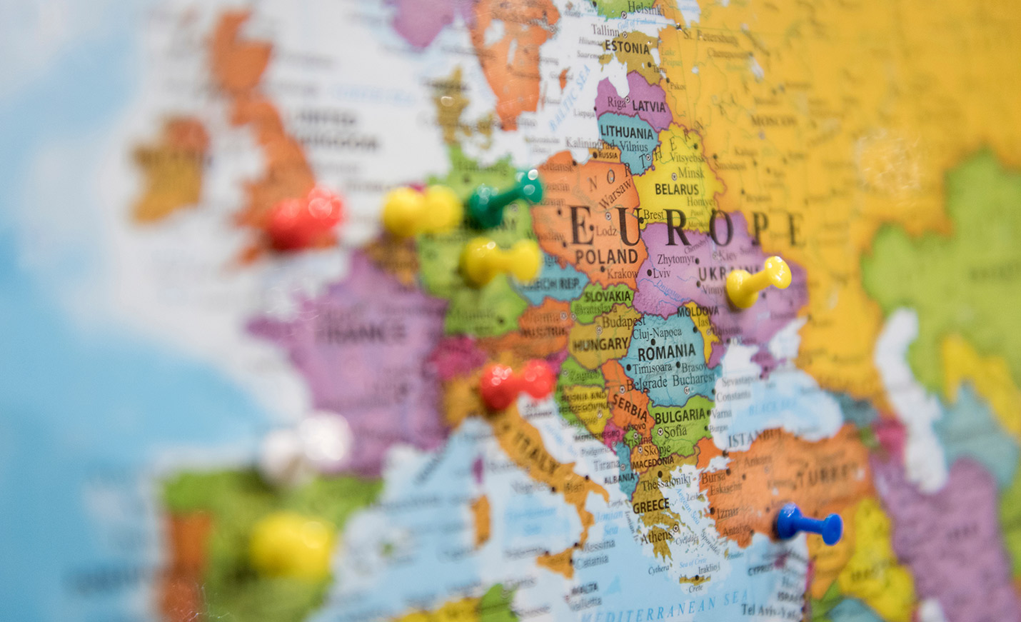 A globe fixed on Europe with pins stuck in