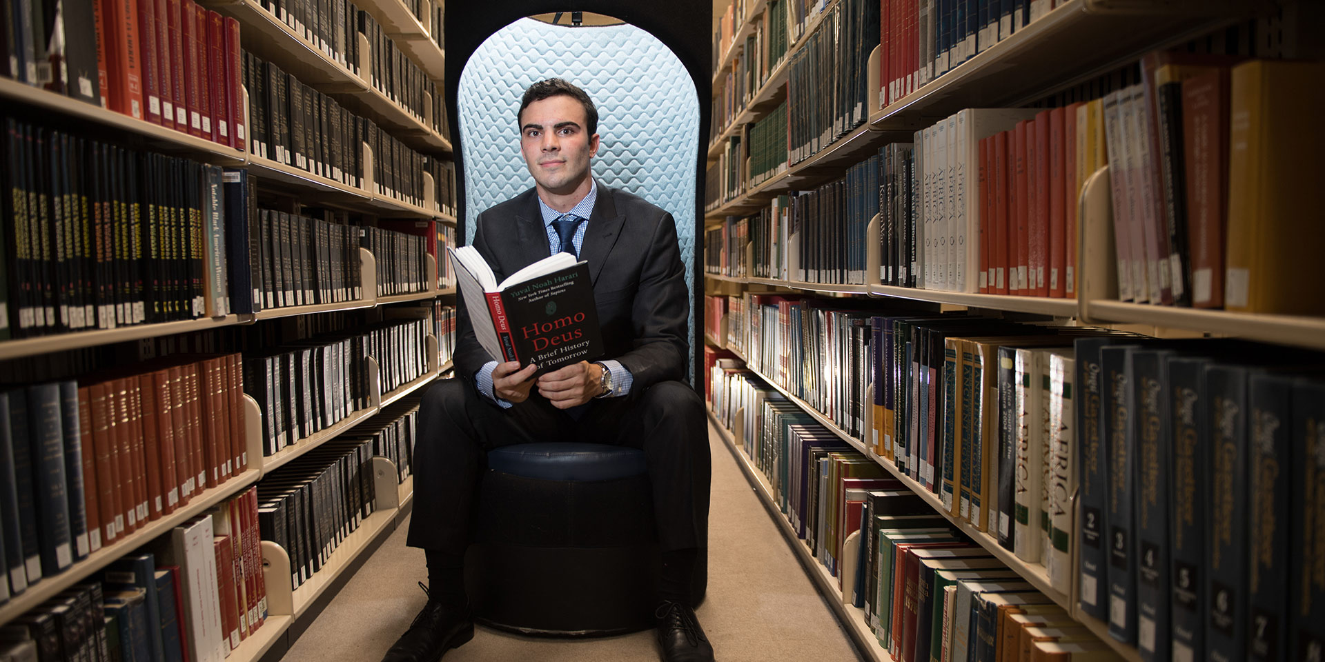 Student sitting in a chair in the library