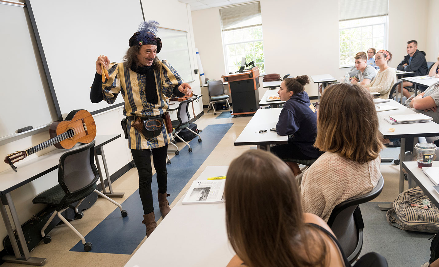 A professor dressed as Don Quixote performs for a class