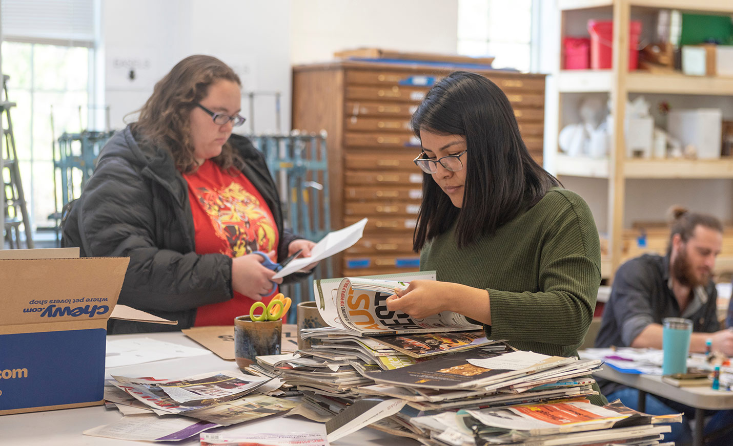 students looking through a stack of magazines
