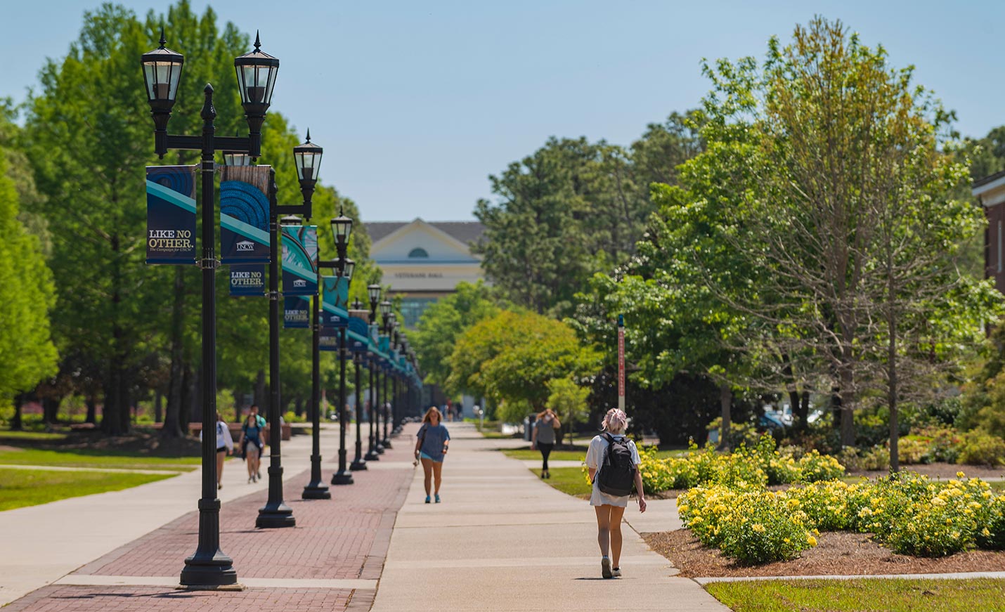 Students walking on Chancellor's Walk on a warm, sunny day