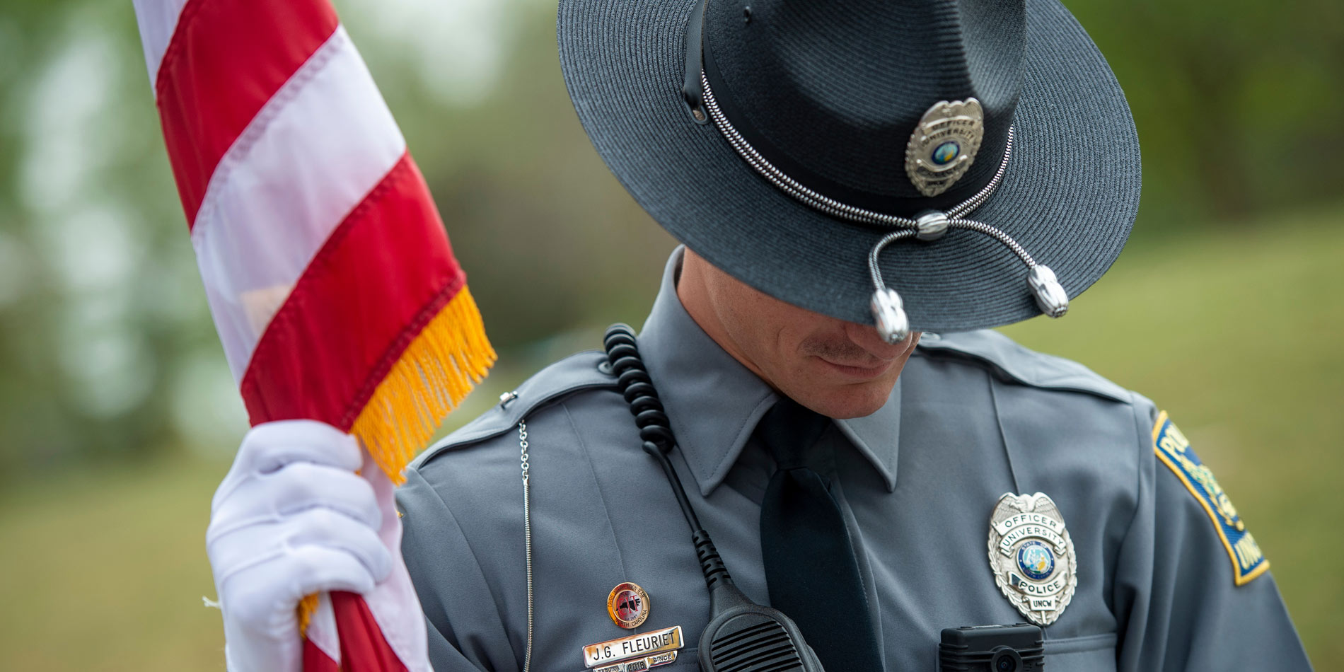 University police holding american flag