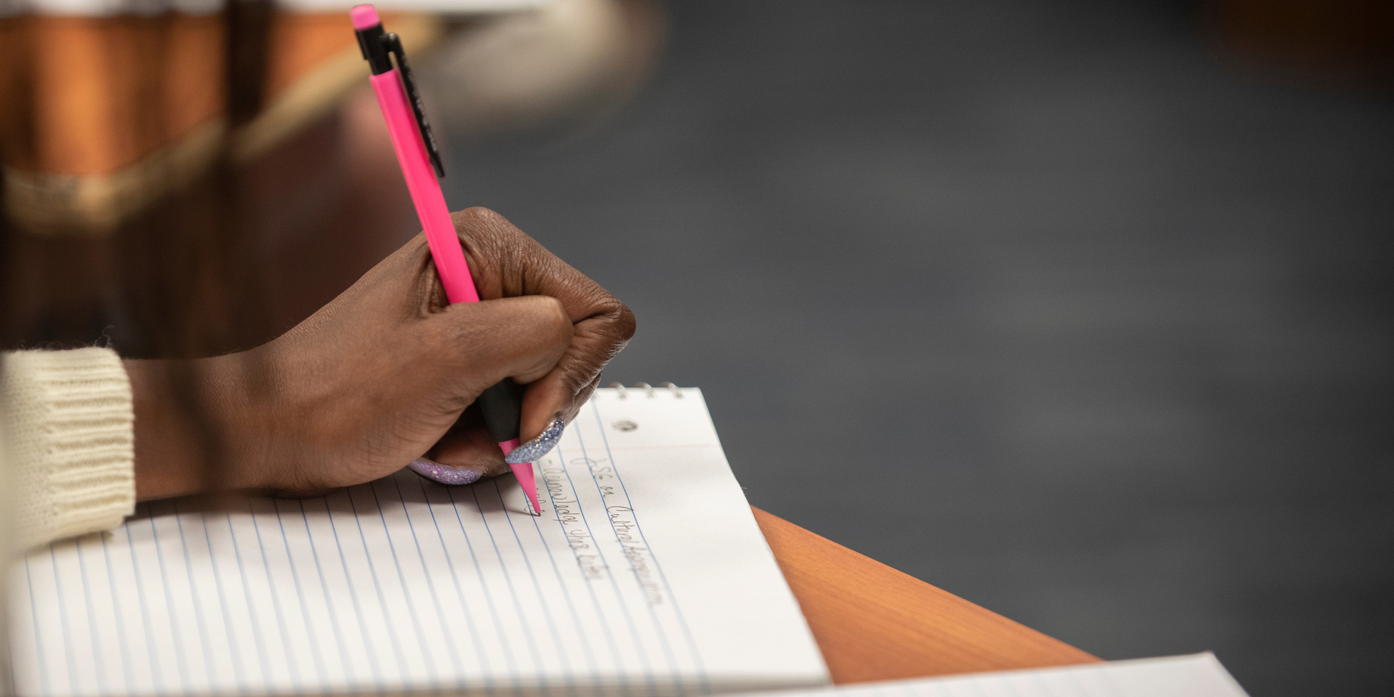 A student takes notes during a class