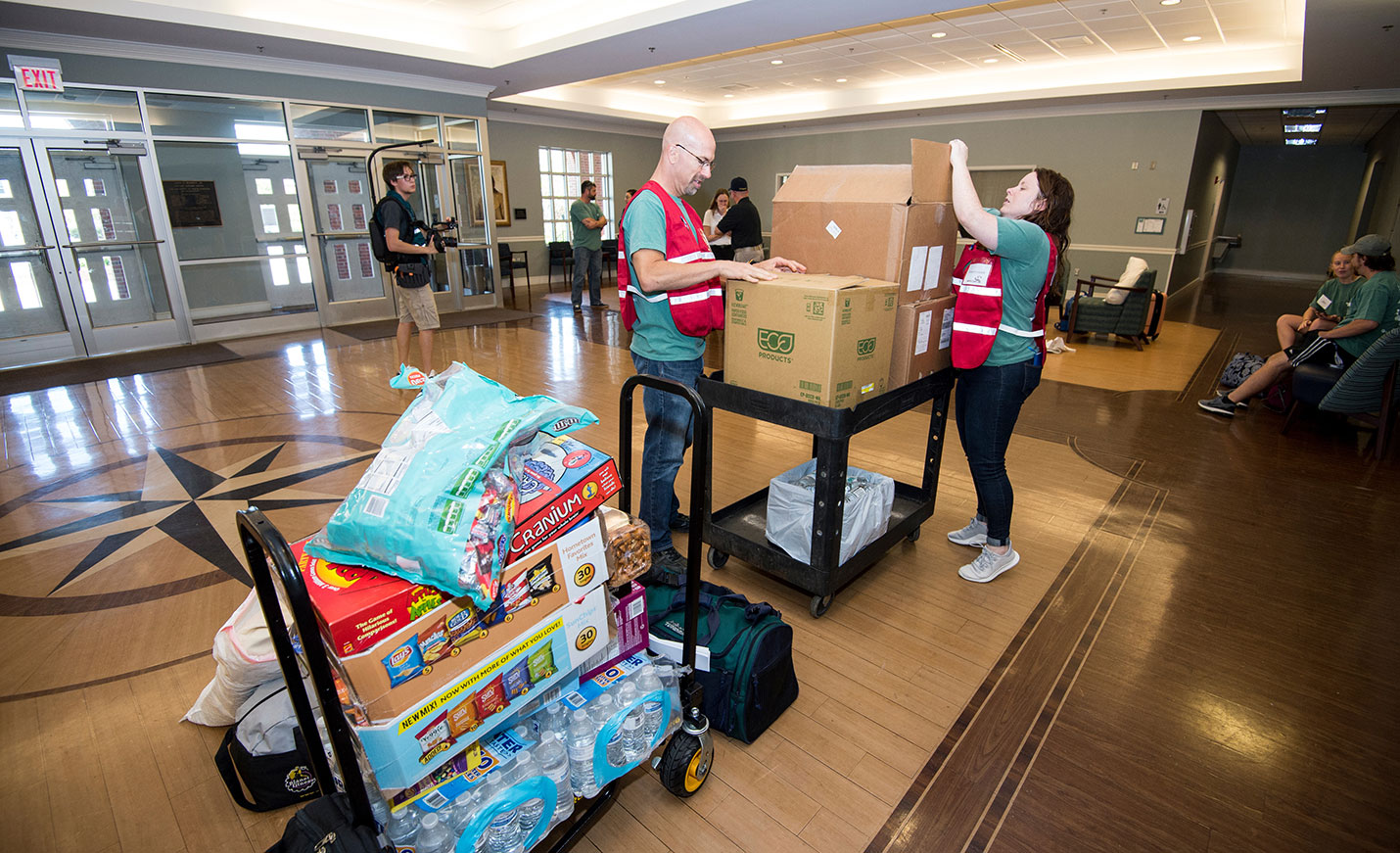people box up disaster supplies