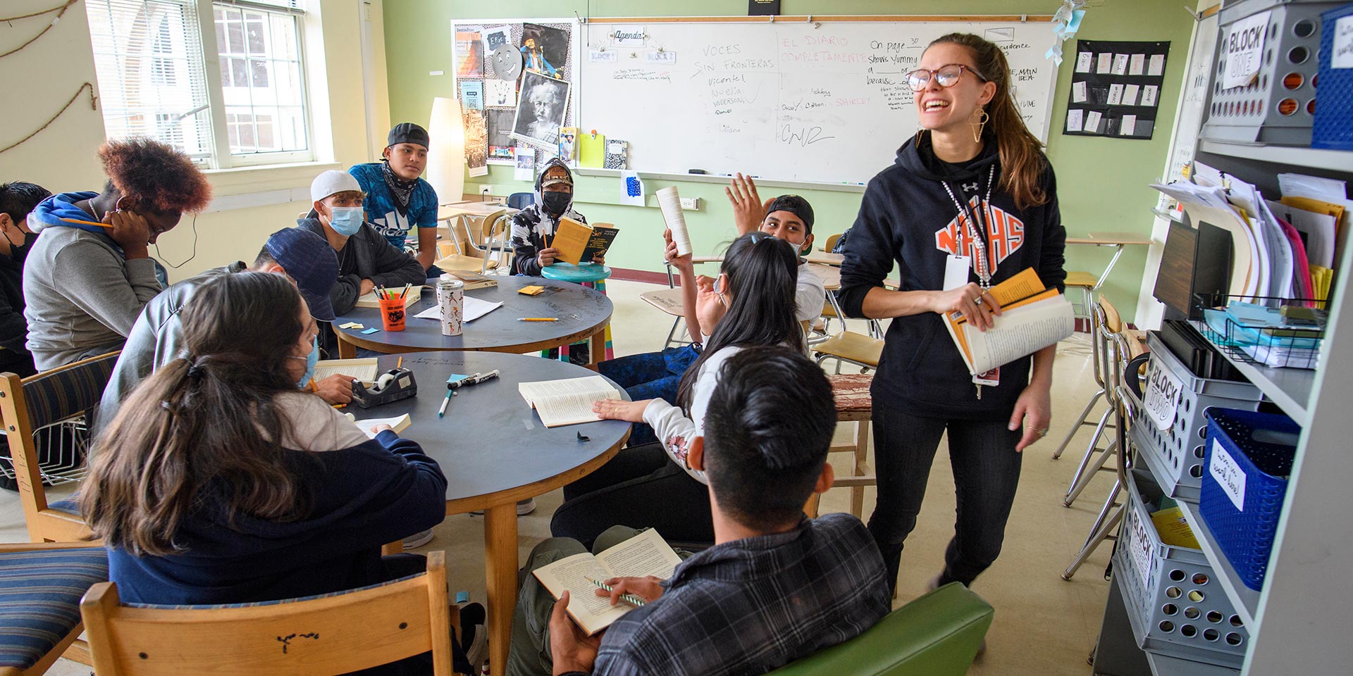 A teacher teaches from a book during a class at New Hanover High School
